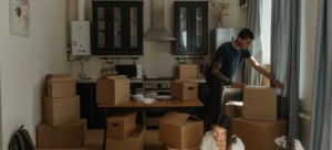 A man and a woman are packing kitchen appliances