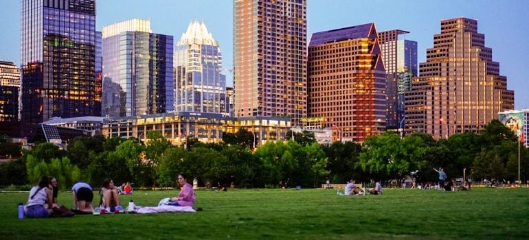 People on picnic in front of large buildings in Austin